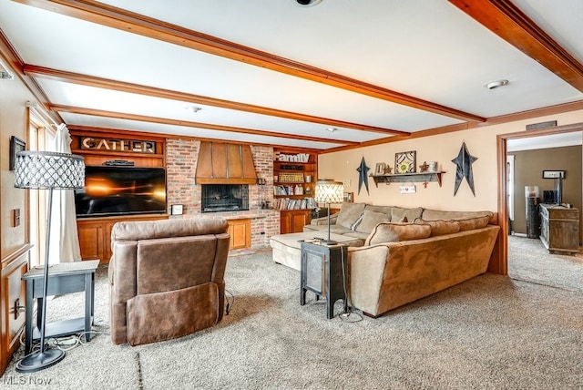 carpeted living room with a brick fireplace, built in features, and beam ceiling