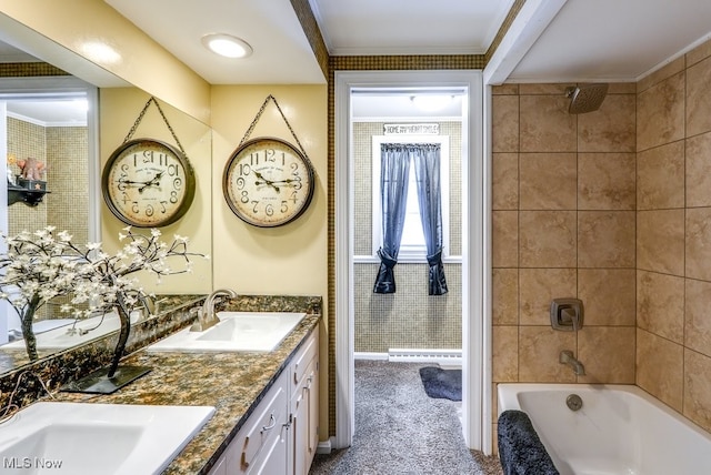 bathroom featuring ornamental molding, tiled shower / bath, and vanity