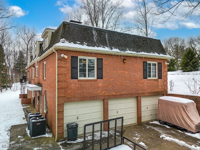 exterior space featuring a garage and central AC unit