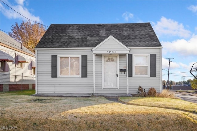 bungalow-style home with a front lawn