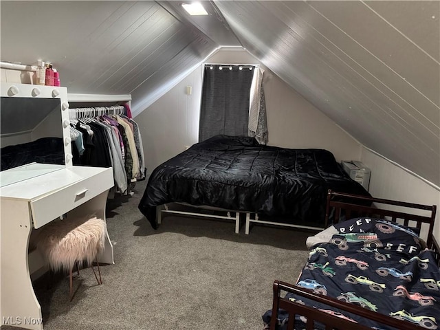 bedroom with vaulted ceiling and carpet floors