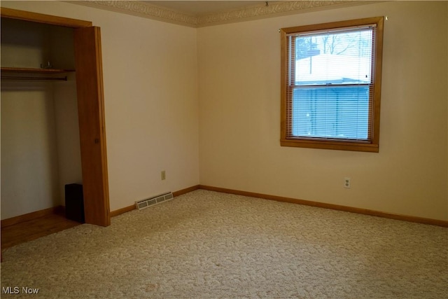 unfurnished bedroom featuring carpet flooring and a closet