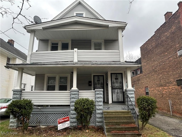 view of front of home with a balcony and a porch