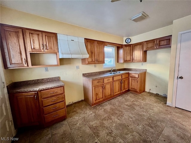 kitchen with sink and wall chimney exhaust hood