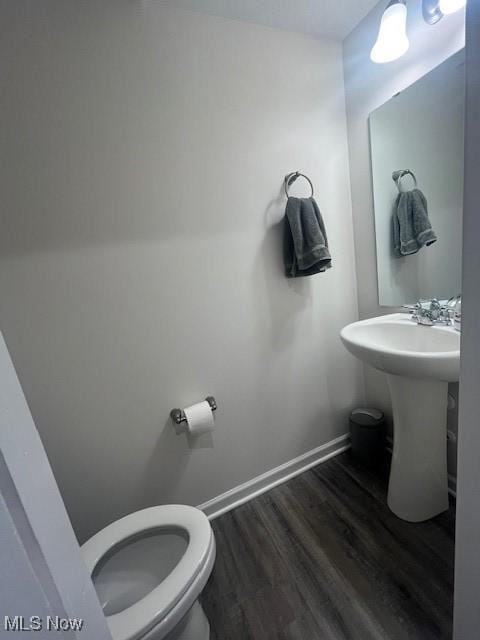 bathroom with hardwood / wood-style floors and toilet