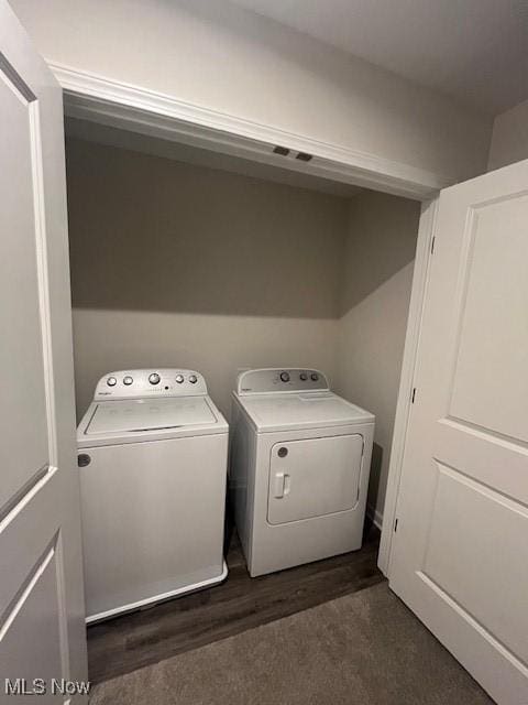 washroom featuring separate washer and dryer and dark hardwood / wood-style floors