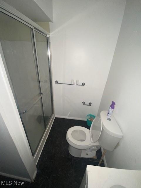 bathroom with toilet, walk in shower, and vanity