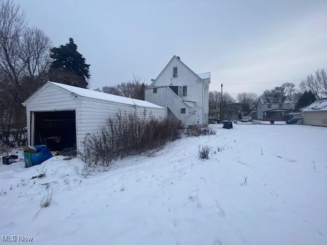 view of snow covered exterior featuring a garage