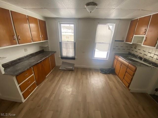 kitchen featuring brown cabinetry and dark countertops