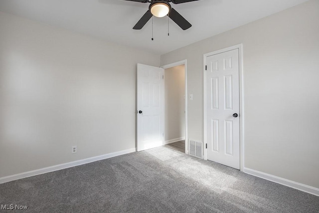 empty room with ceiling fan and carpet flooring