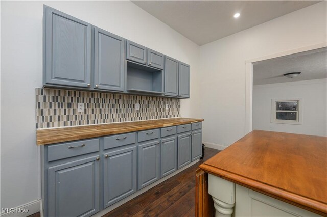 kitchen featuring tasteful backsplash and dark hardwood / wood-style floors