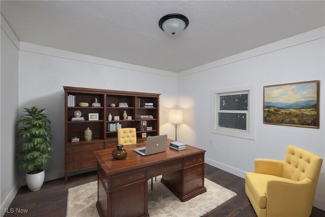 home office featuring dark wood-type flooring and a textured ceiling