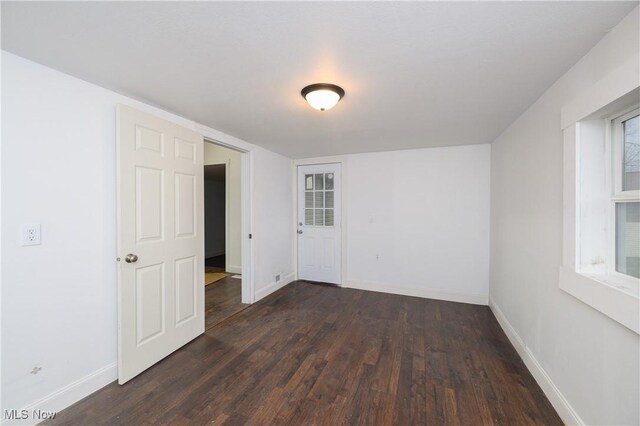 empty room featuring dark wood-type flooring