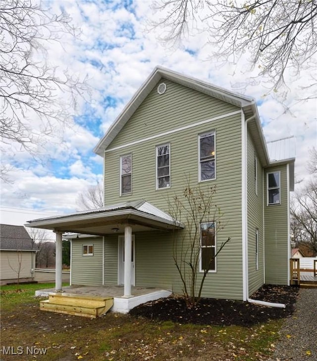 back of property featuring a porch