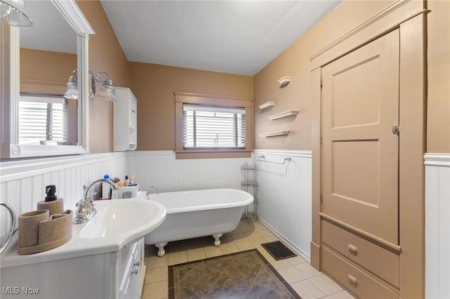 bathroom featuring a bath, tile patterned flooring, and vanity