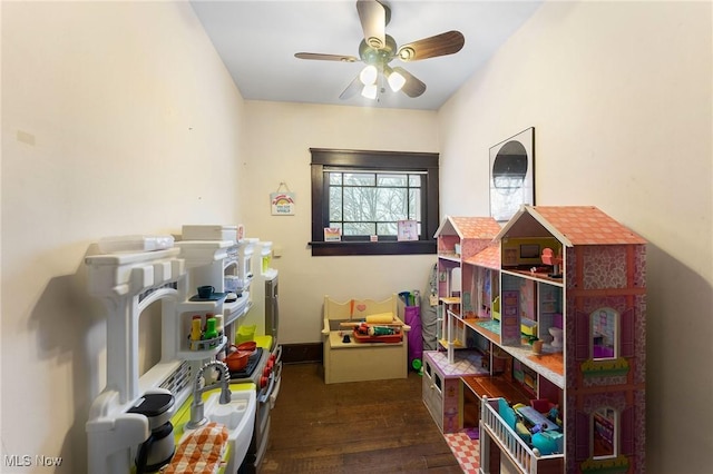 rec room featuring ceiling fan and dark hardwood / wood-style floors