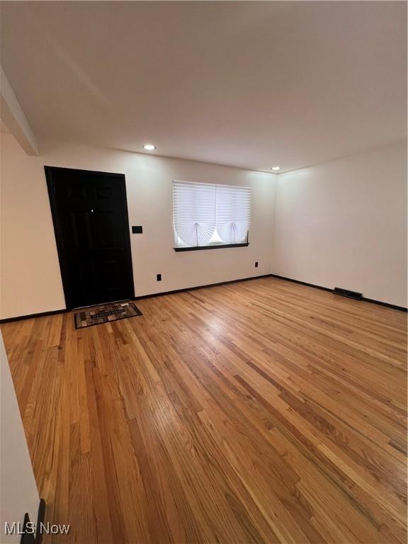 unfurnished room with light hardwood / wood-style flooring