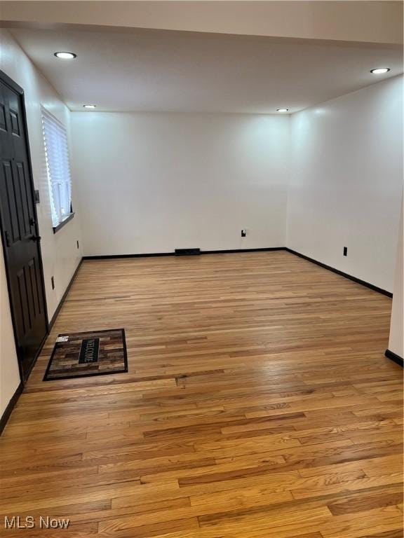 spare room featuring light wood-type flooring