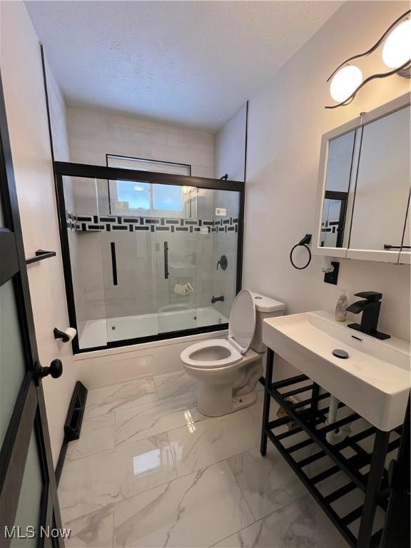 bathroom with toilet and enclosed tub / shower combo