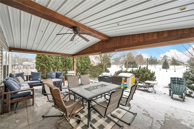 snow covered patio featuring ceiling fan and an outdoor living space