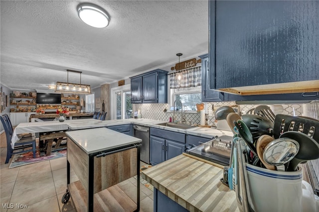 kitchen with sink, stainless steel dishwasher, and blue cabinets