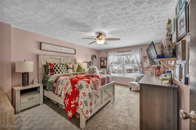 bedroom with a textured ceiling, ceiling fan, and light colored carpet