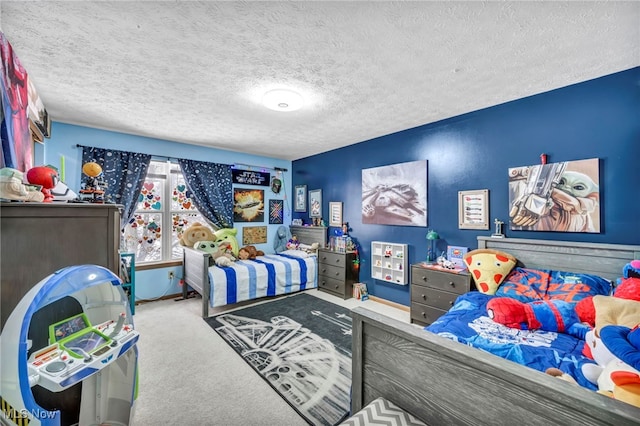 bedroom featuring a textured ceiling and carpet