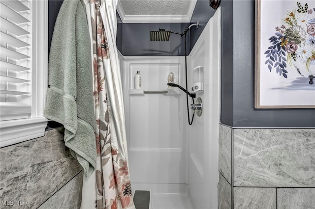 bathroom featuring a shower with curtain, a textured ceiling, and tile walls