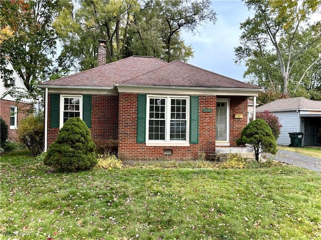 bungalow-style house featuring a front yard