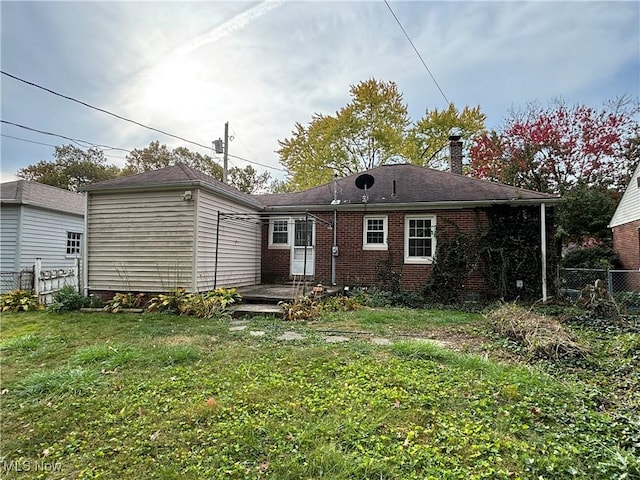 back of house with a lawn