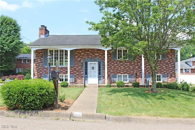 raised ranch featuring a front lawn