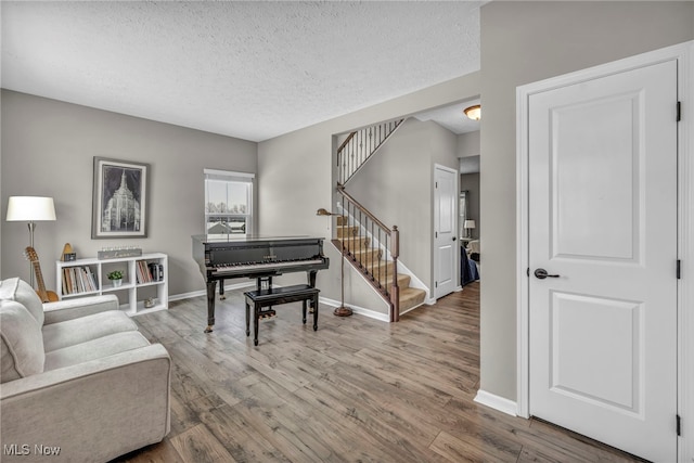 living room with a textured ceiling and wood-type flooring