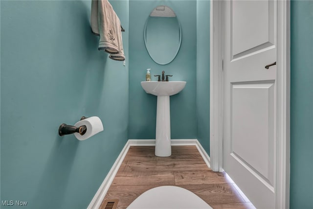 bathroom with hardwood / wood-style flooring