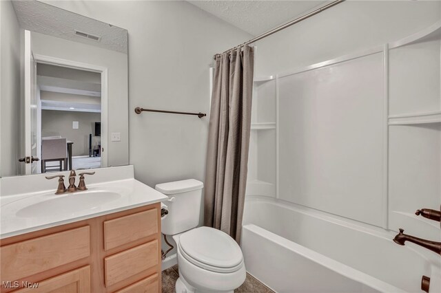 full bathroom featuring a textured ceiling, toilet, vanity, and shower / tub combo with curtain