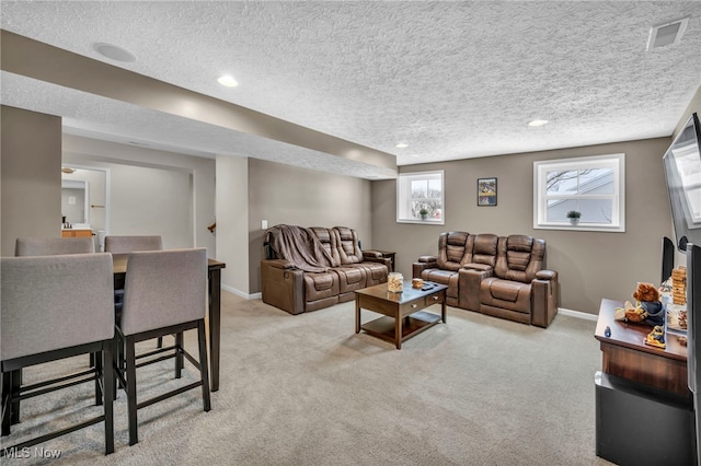 carpeted living room featuring a textured ceiling