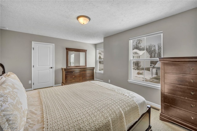 carpeted bedroom with multiple windows and a textured ceiling