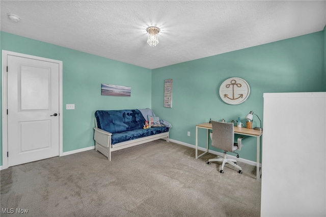 carpeted home office with a textured ceiling