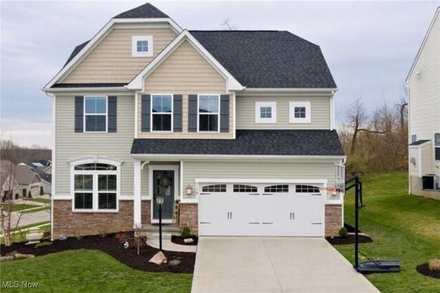 craftsman-style house featuring a garage and a front yard