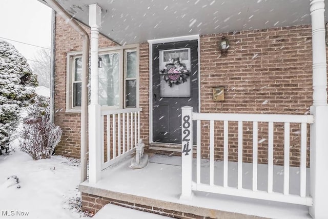 view of snow covered property entrance