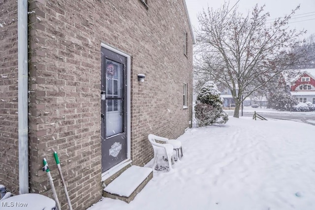 view of snow covered property entrance