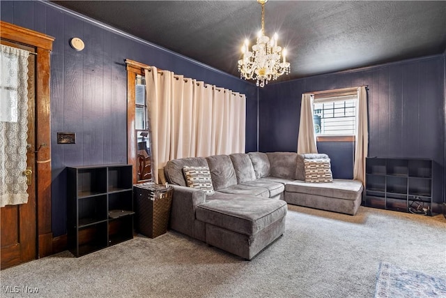 carpeted living room with an inviting chandelier, wooden walls, and a textured ceiling