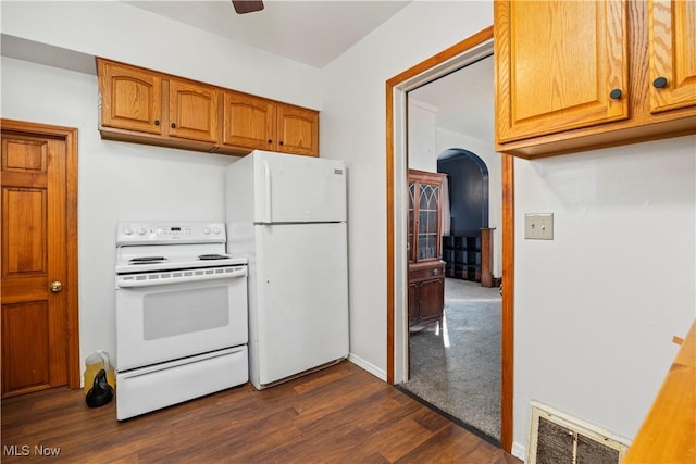 kitchen featuring white appliances, dark wood-type flooring, and ceiling fan