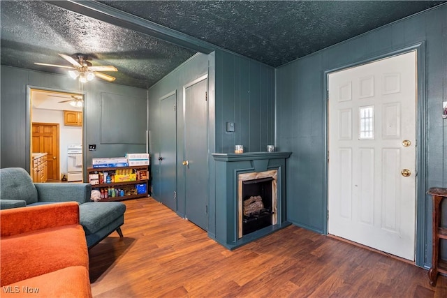 interior space featuring ceiling fan, hardwood / wood-style floors, and a textured ceiling