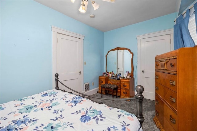 bedroom featuring dark carpet