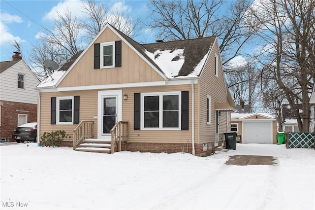 view of front of property with a garage and an outbuilding