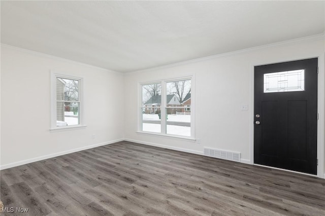 entryway with hardwood / wood-style floors and crown molding