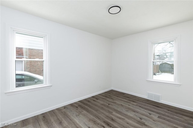 spare room featuring dark hardwood / wood-style flooring