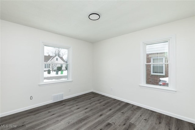 unfurnished room featuring dark hardwood / wood-style flooring