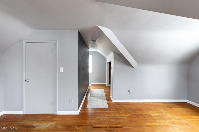 bonus room featuring lofted ceiling and wood-type flooring