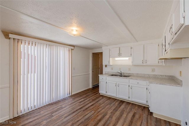 kitchen featuring sink, white cabinetry, a textured ceiling, a healthy amount of sunlight, and dark hardwood / wood-style floors